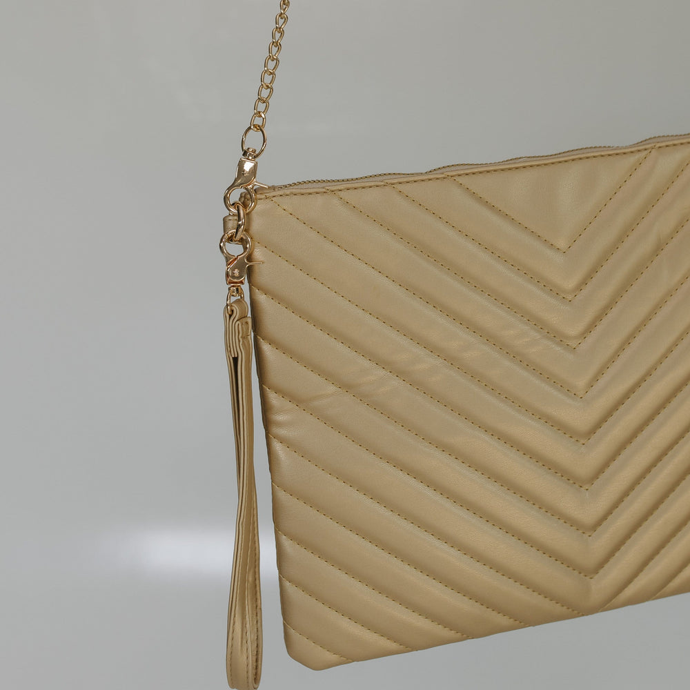 Beige clutch bag with a chain strap on a light gray background