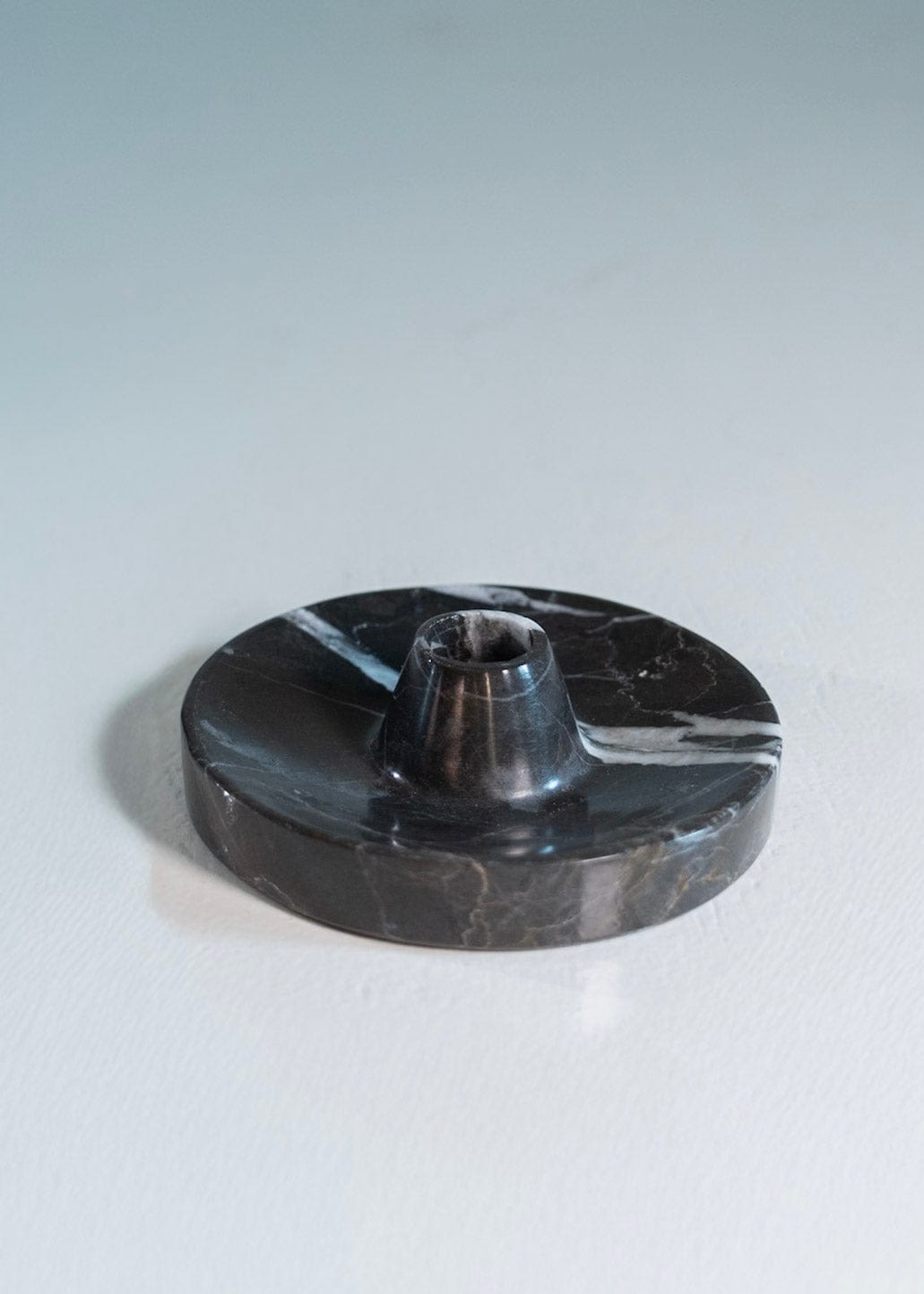 Black marble candle holder on a light gray background