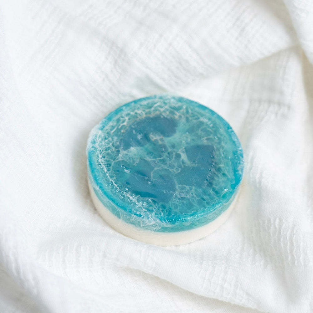 Blue decorative soap on a white textured surface