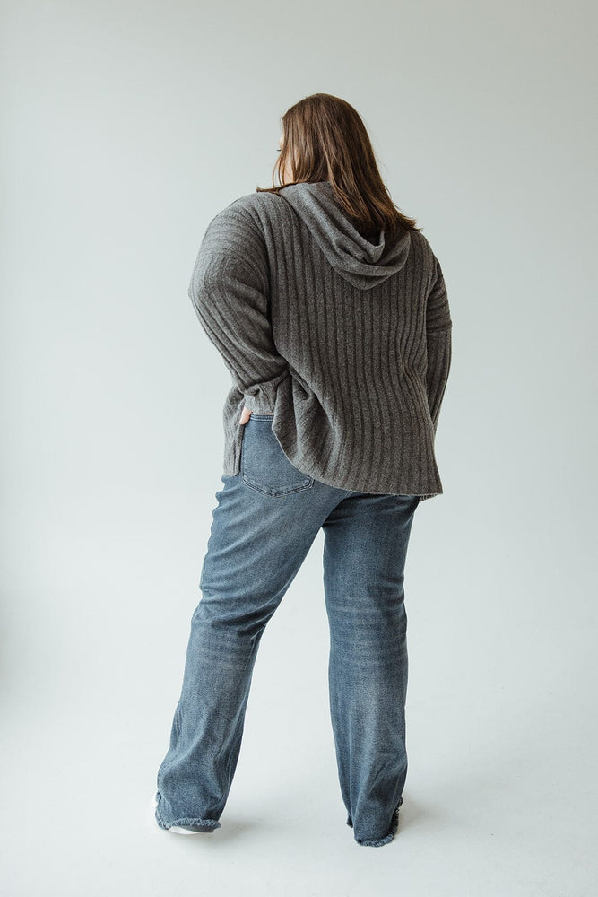 A person wearing a gray ribbed hoodie and Judy Blue High-Waisted Button-Fly Destroyed Hem Straight Leg jeans stands with their back to the camera against a neutral background.