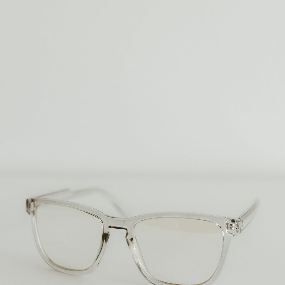 Clear eyeglasses on a light gray background