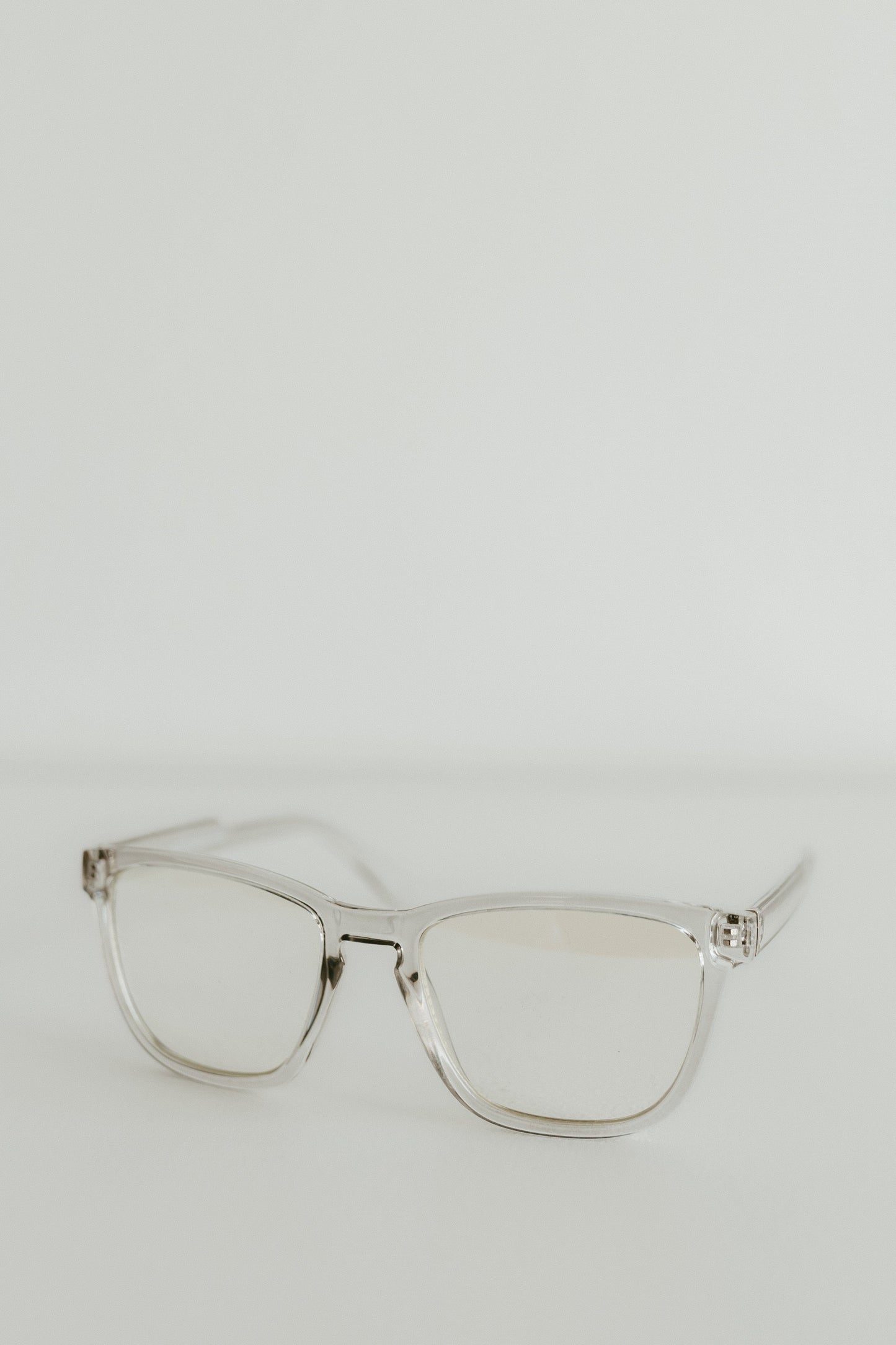 Clear eyeglasses on a light gray background