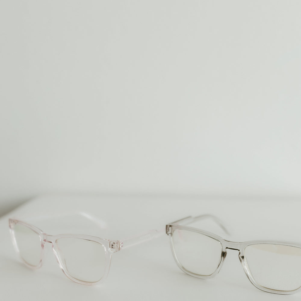 Pair of cat-eye glasses on a light gray background