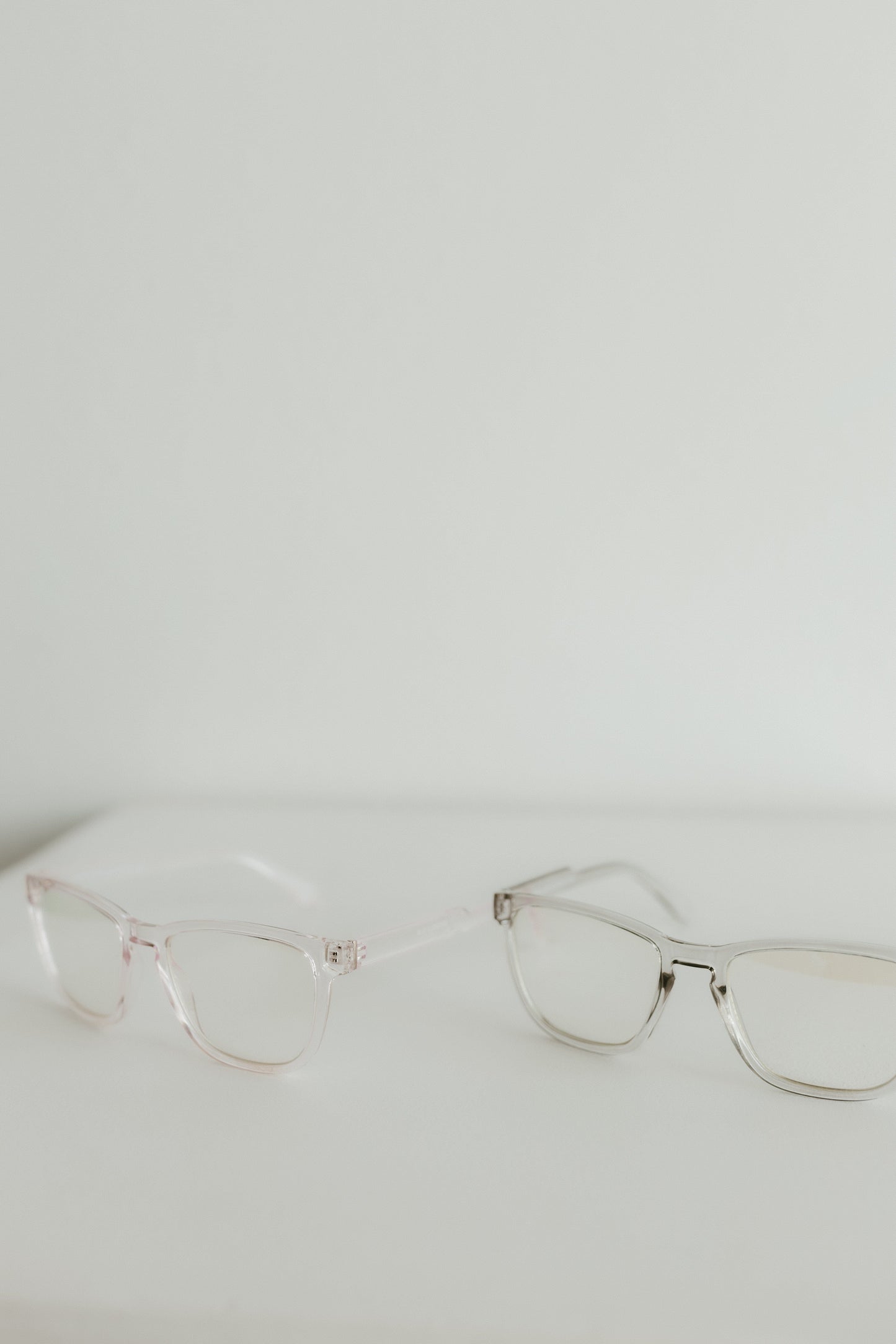 Pair of cat-eye glasses on a light gray background