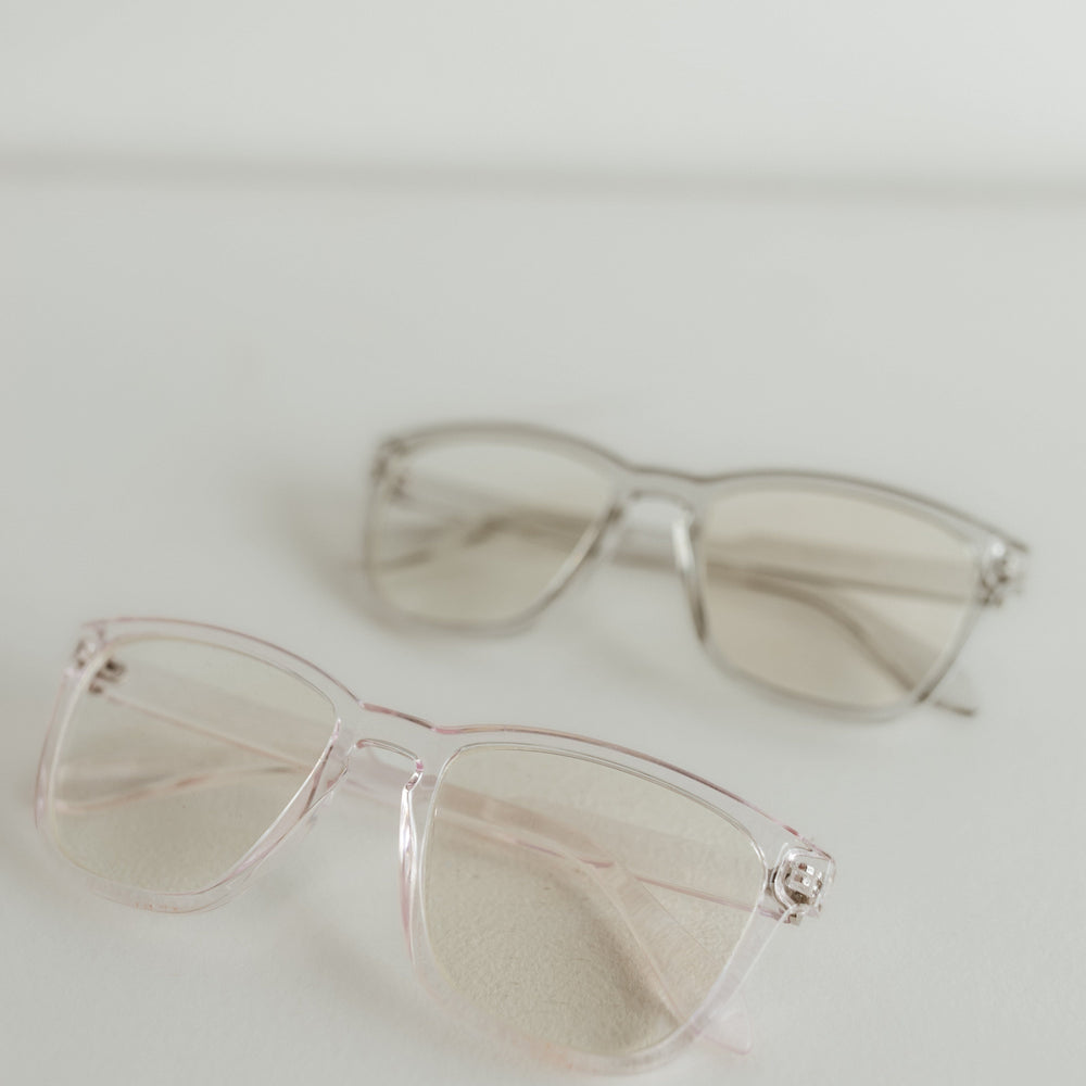 Clear sunglasses on a light gray background