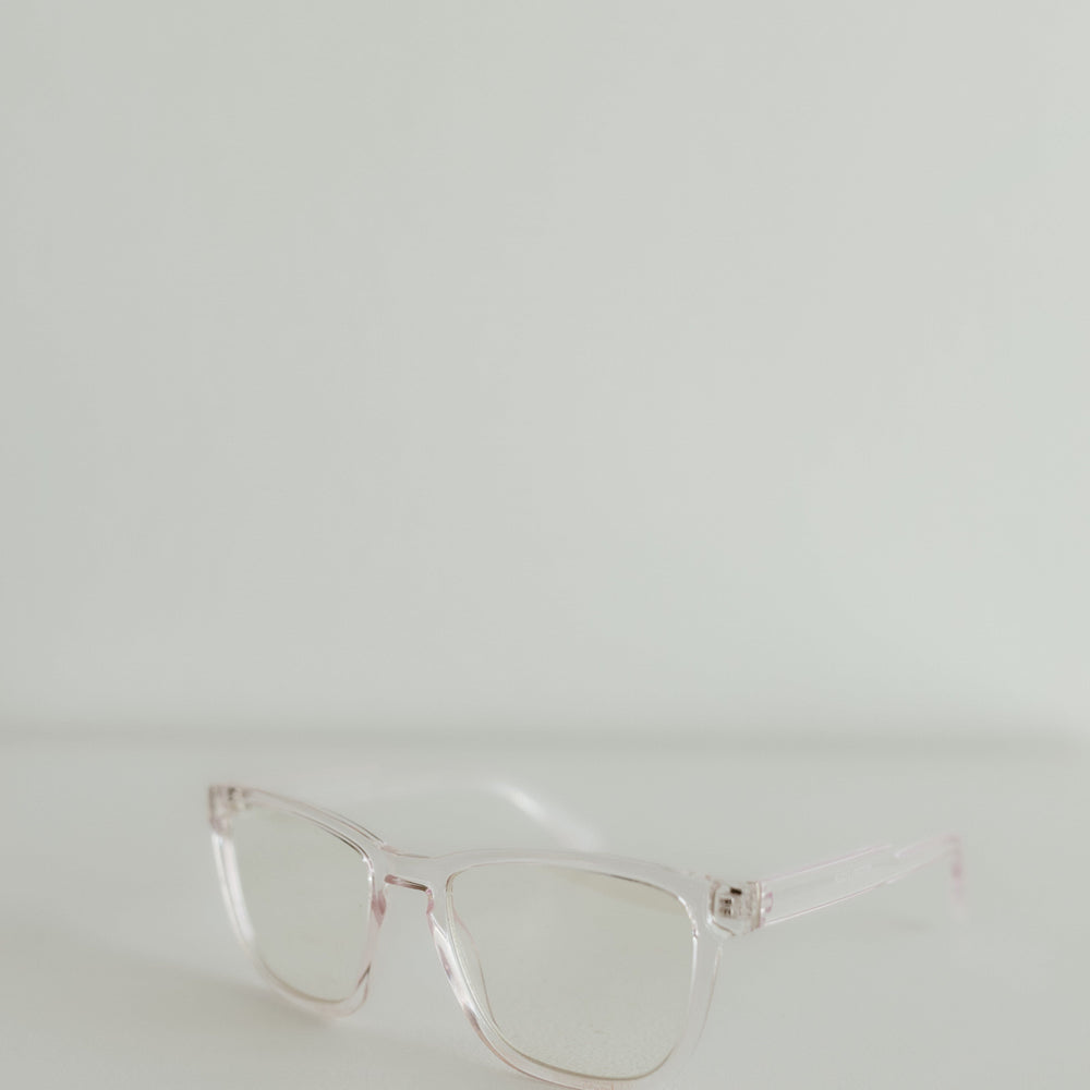 Clear eyeglasses on a light gray background