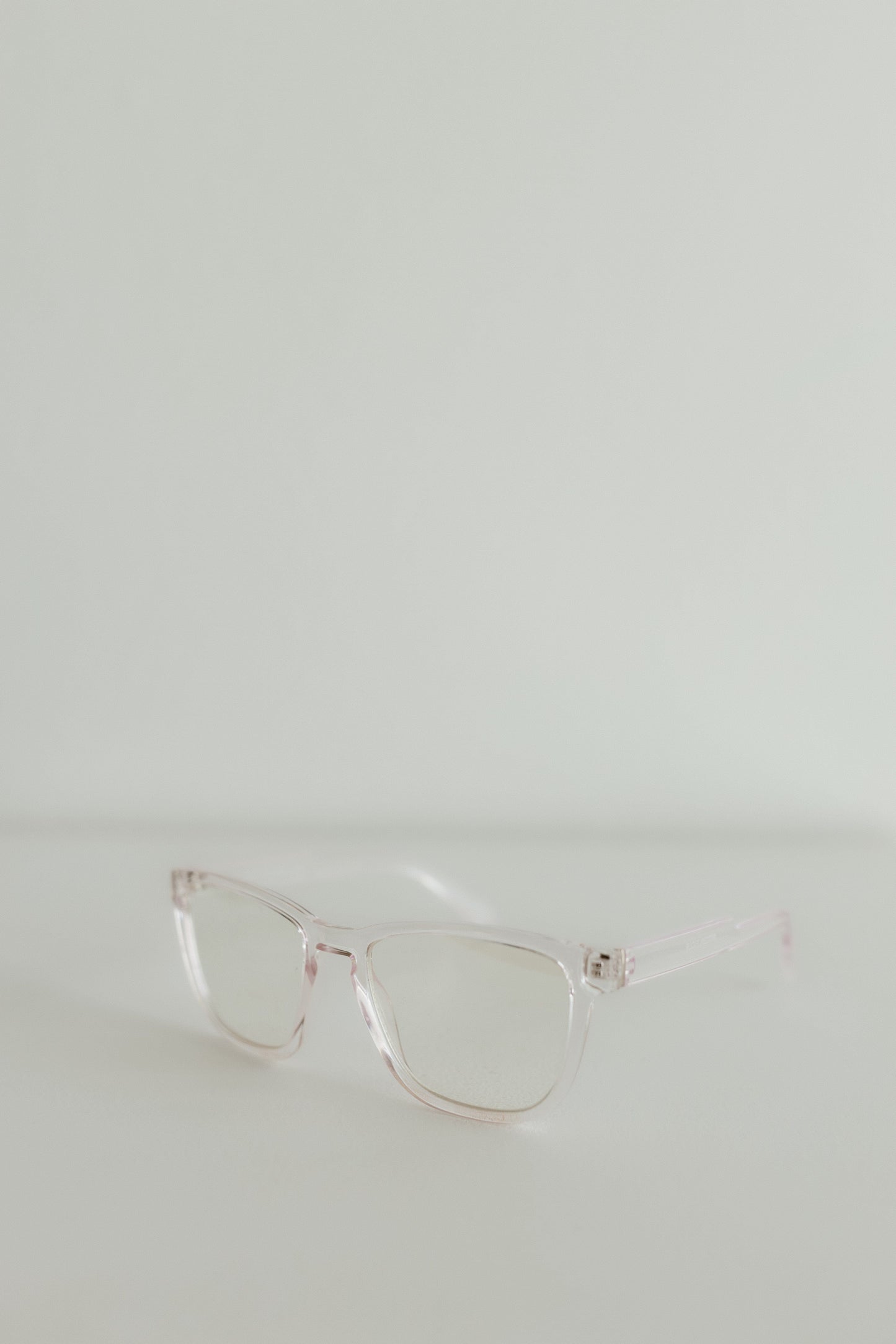 Clear eyeglasses on a light gray background