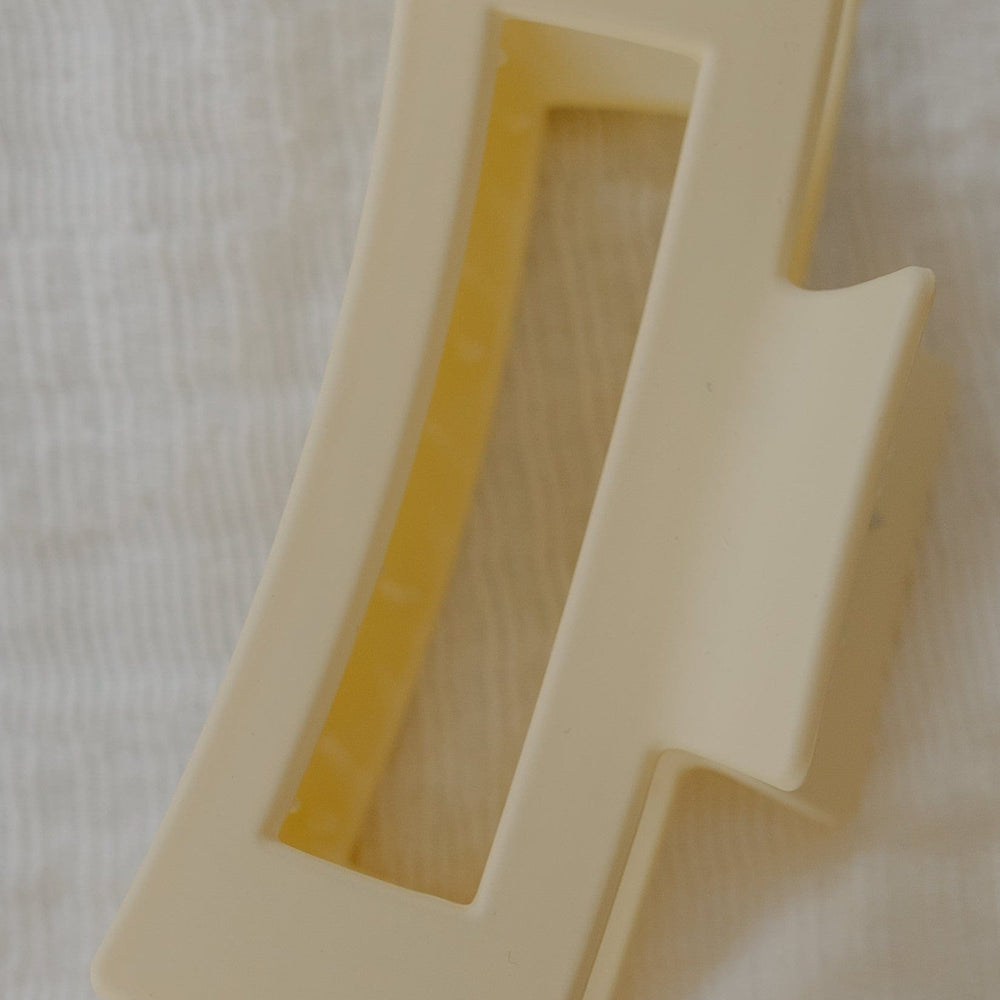 Ivory plastic clip on a white fabric background