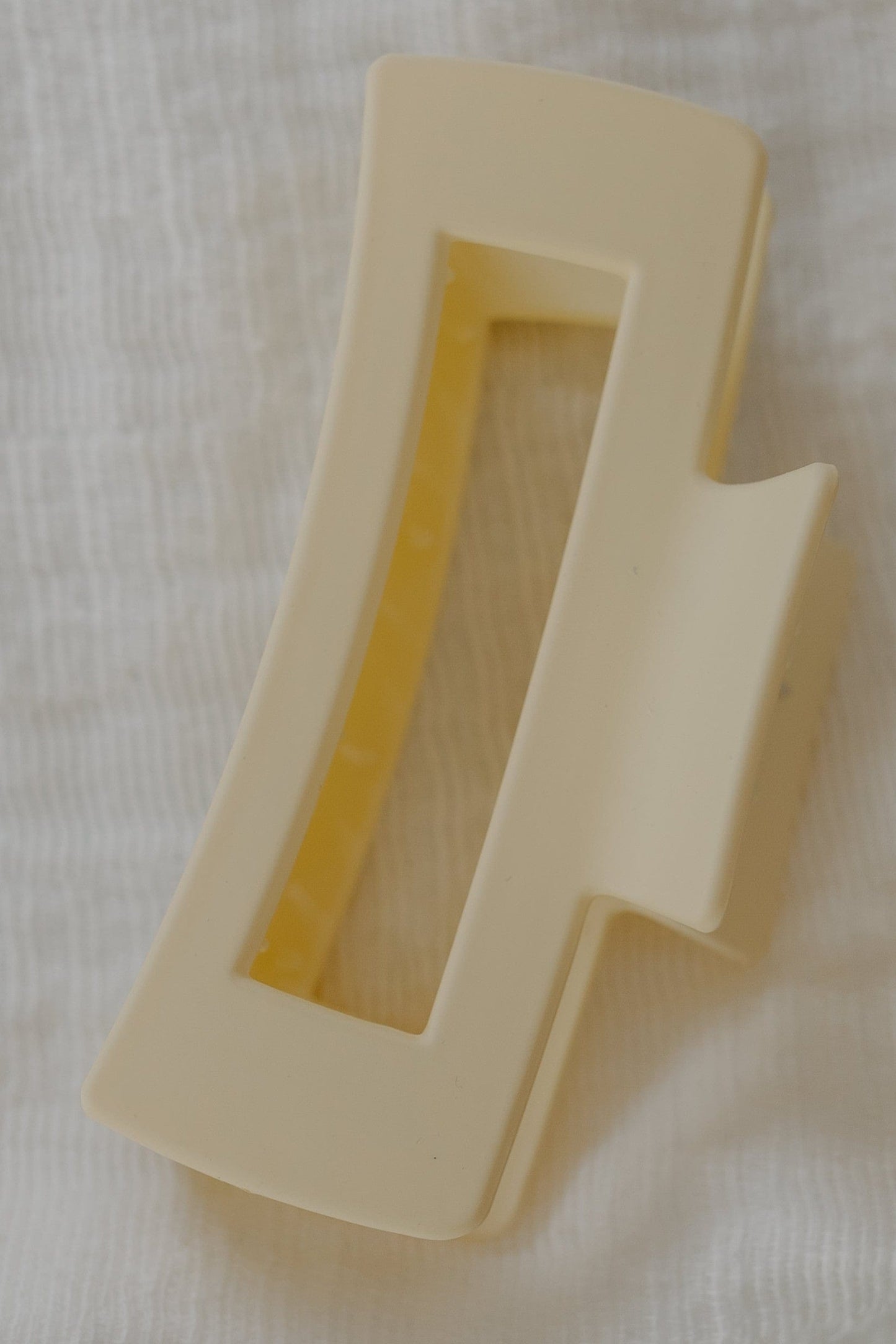 Ivory plastic clip on a white fabric background