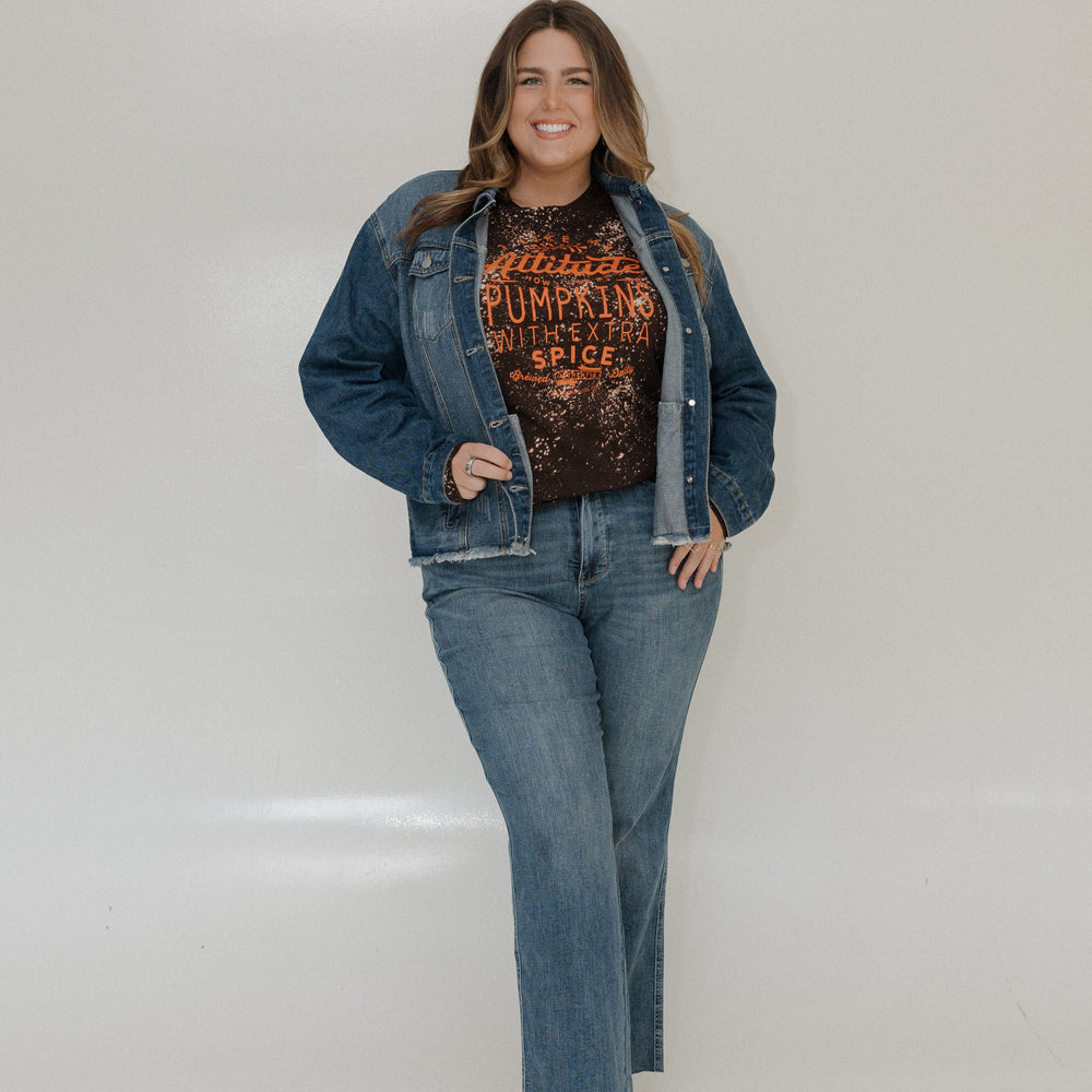 "I LIKE MY ATTITUDE HOW I LIKE MY PUMPKINS WITH EXTRA SPICE" LONG-SLEEVE TEE Love Marlow Woman wearing a denim jacket and jeans with a graphic t-shirt against a white background