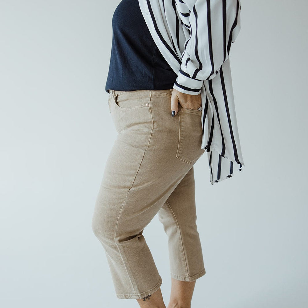 Person standing sideways wearing a blue Judy Blue top, striped overcoat, JUDY BLUE NON-DISTRESSED CAPRI IN WASHED KHAKI by Judy Blue, and beige flats against a plain background—a perfect summer style ensemble.