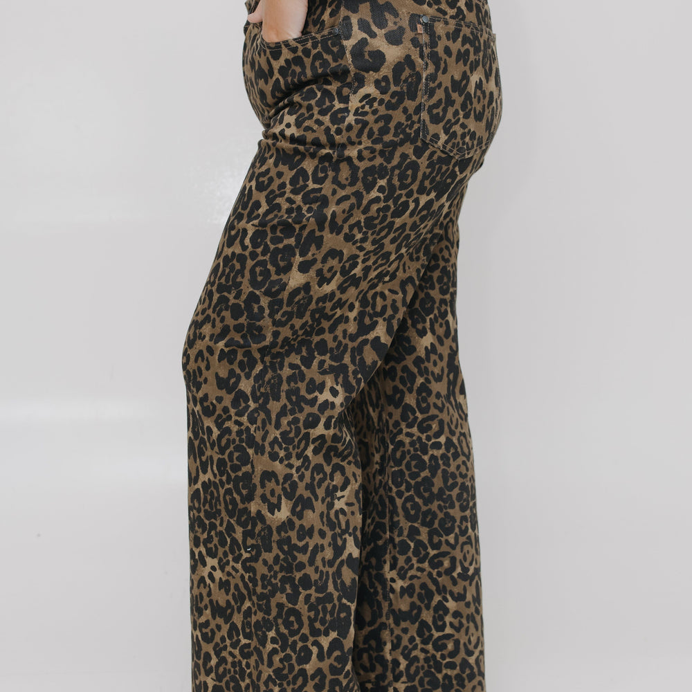 Leopard print pants worn by a person on a white background