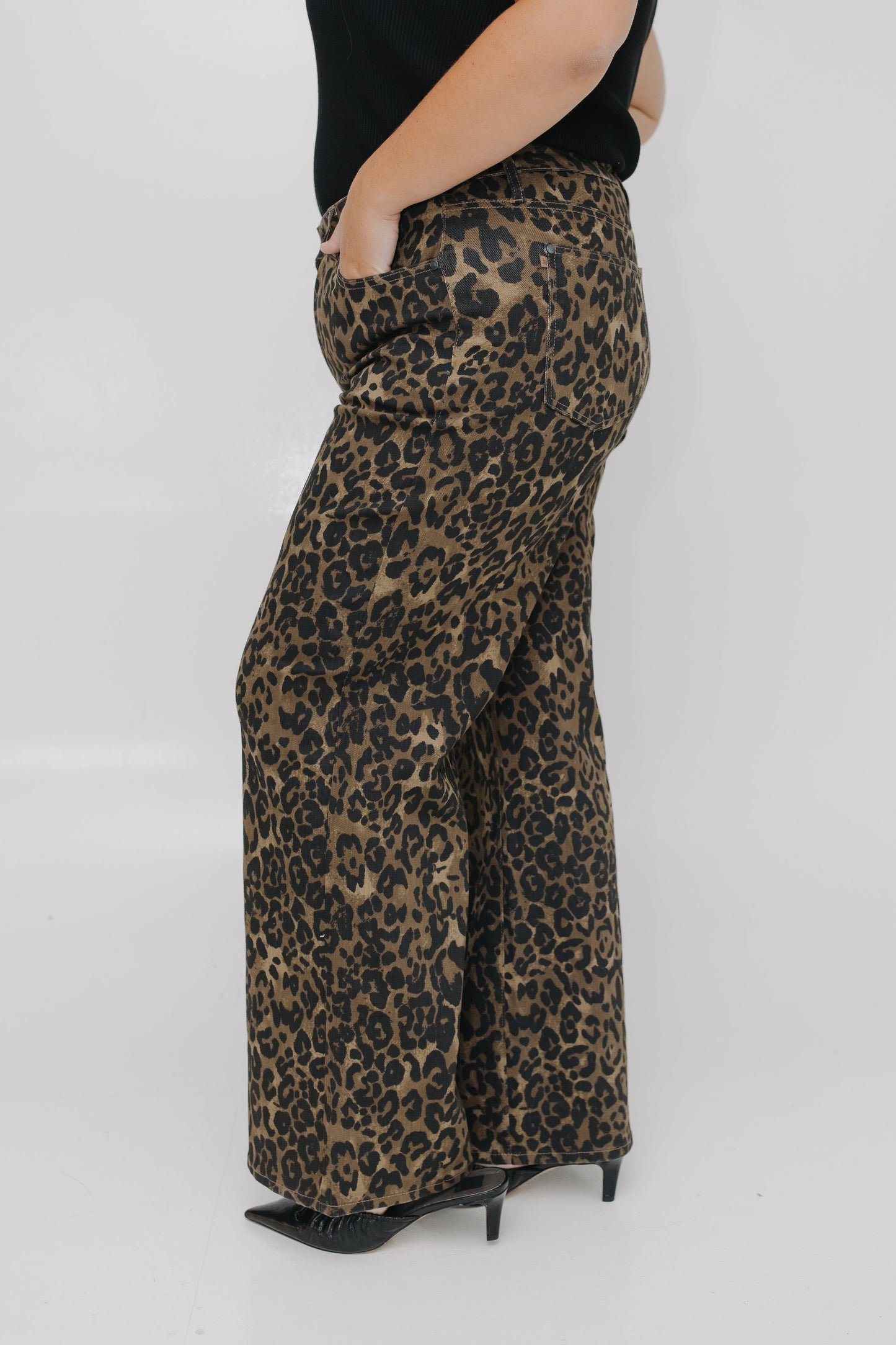 Leopard print pants worn by a person on a white background