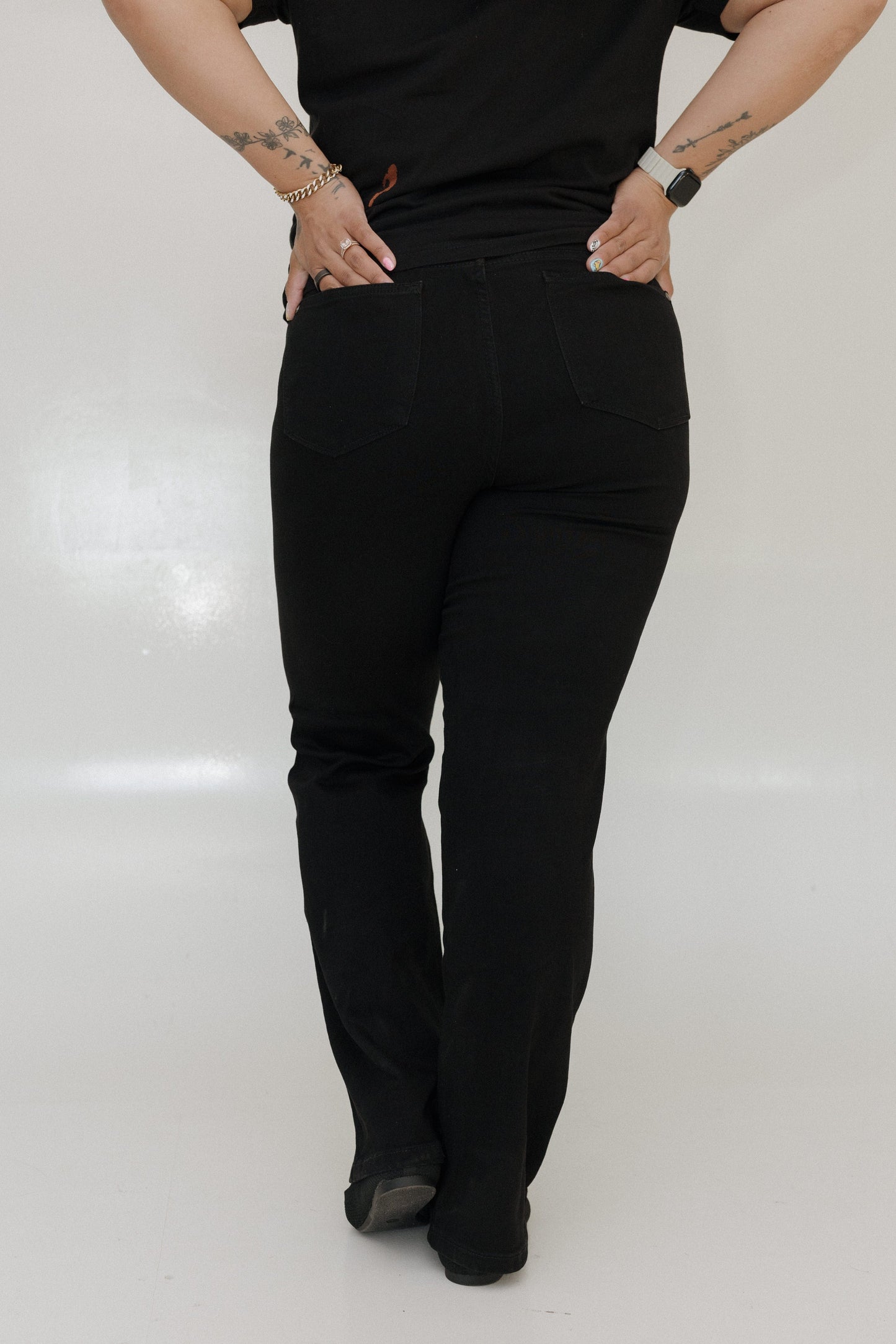 Person wearing black pants on a white background