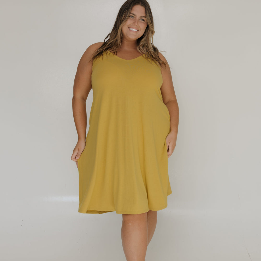 Woman wearing a yellow dress against a white background