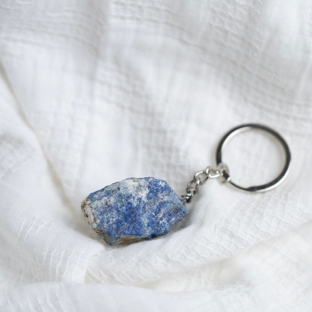 Keychain with a Labradorite stone pendant on a white fabric background