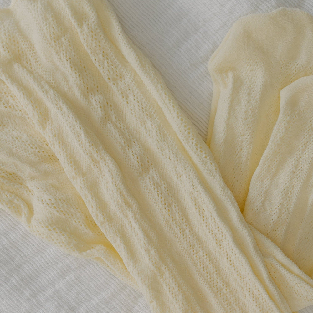 Cream-colored lace socks on a light gray background