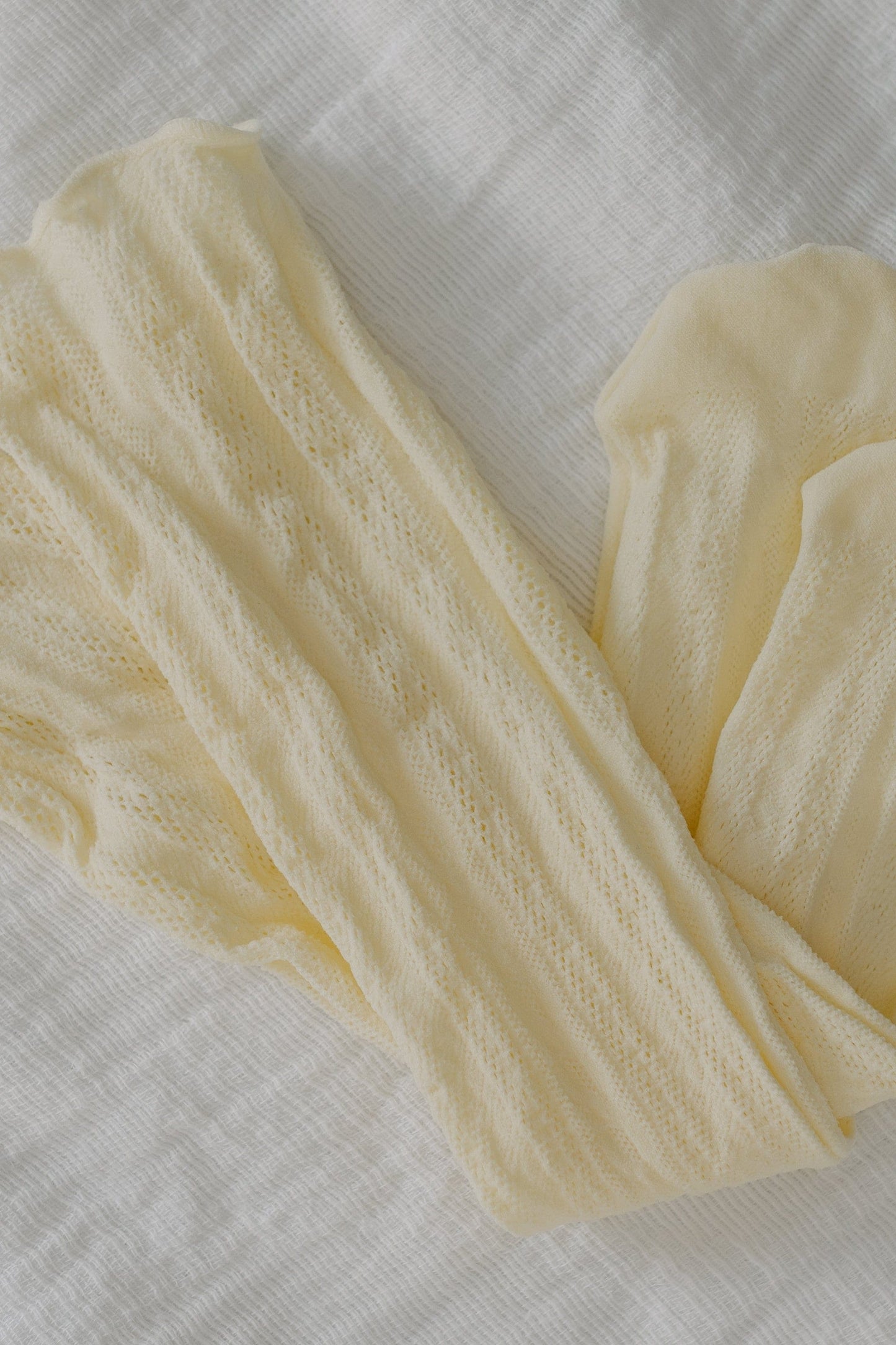 Cream-colored lace socks on a light gray background