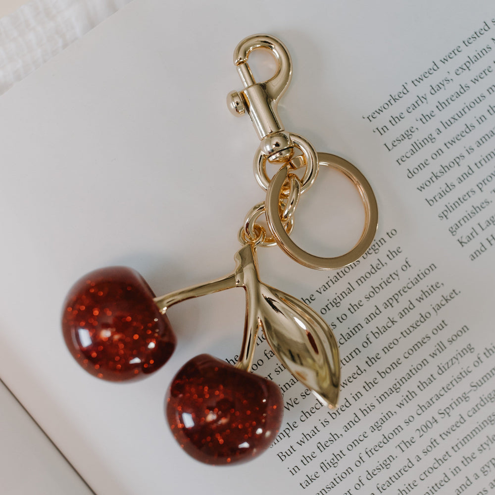 Keychain with cherry design on an open book