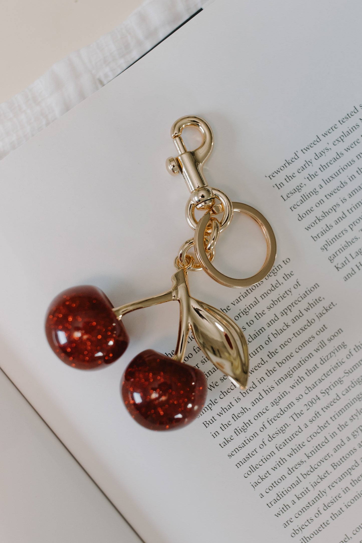 Keychain with cherry design on an open book