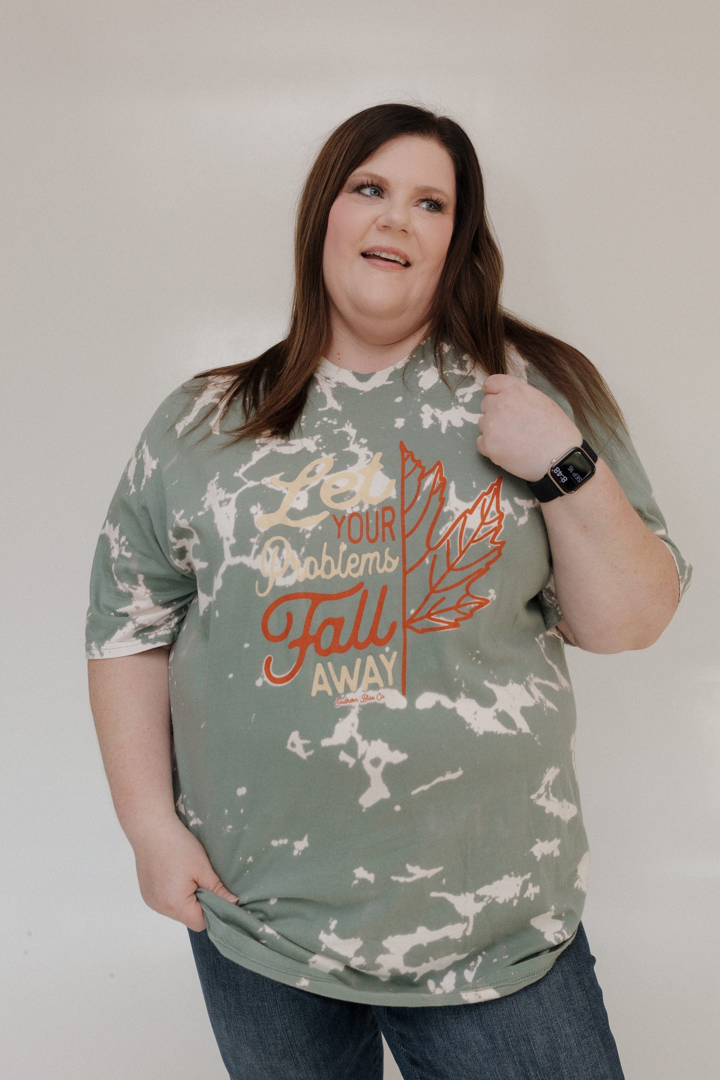 "LET YOUR PROBLEMS FALL AWAY" GRAPHIC TEE
A person beams in the Love Marlow "LET YOUR PROBLEMS FALL AWAY" graphic tee, featuring a leaf design and an inspirational message, perfect for fall fashion.
