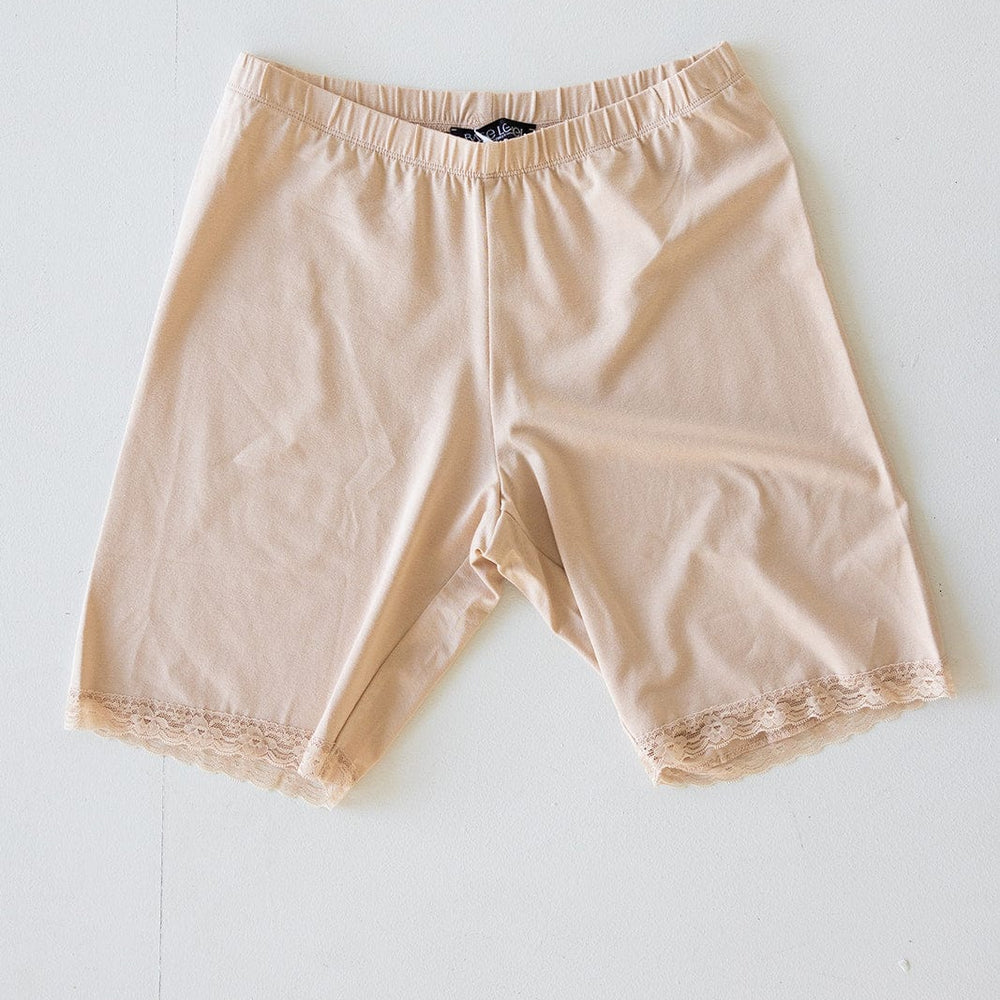 Beige shorts with lace trim on the hem, featuring a comfortable elastic waistband, laid flat against a white background.