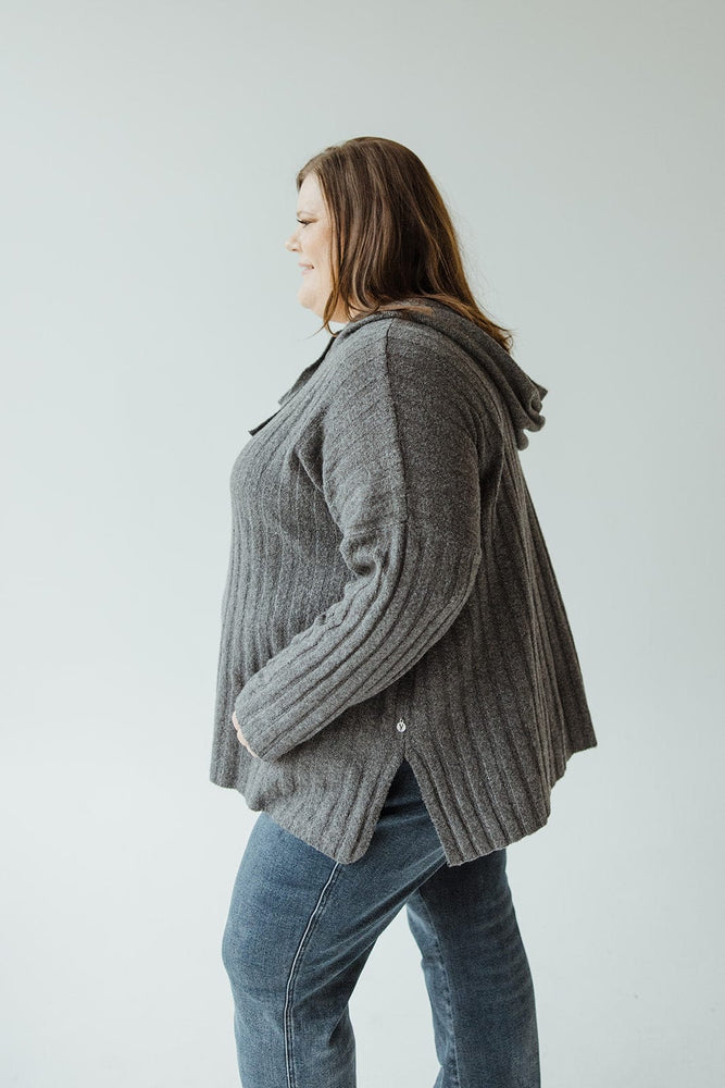 Person in a Yesta LINEAR ATHLEISURE HOODIE and blue jeans, standing sideways against a plain background, exuding an elevated fashion sense.