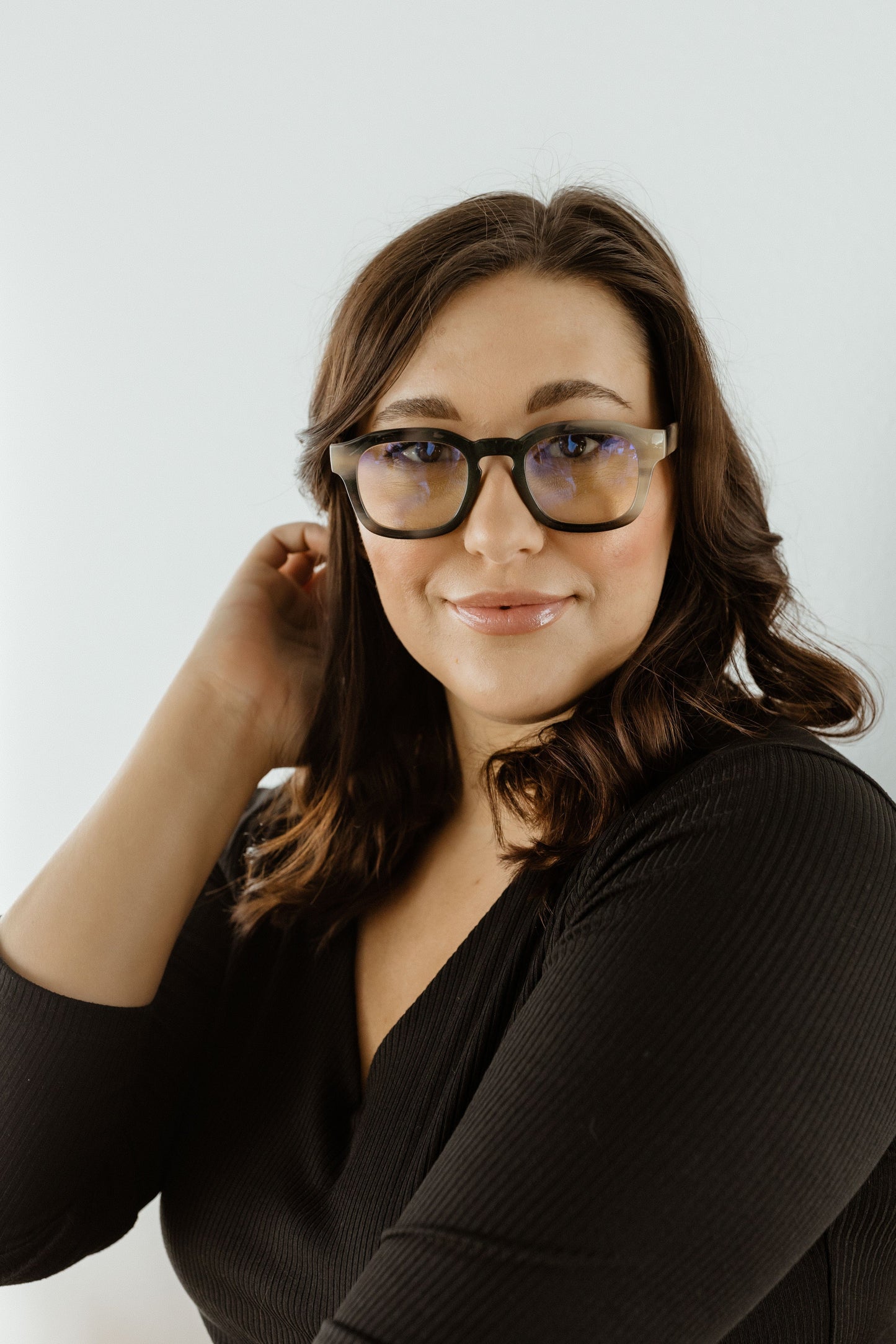 Woman wearing glasses with a plain white background
