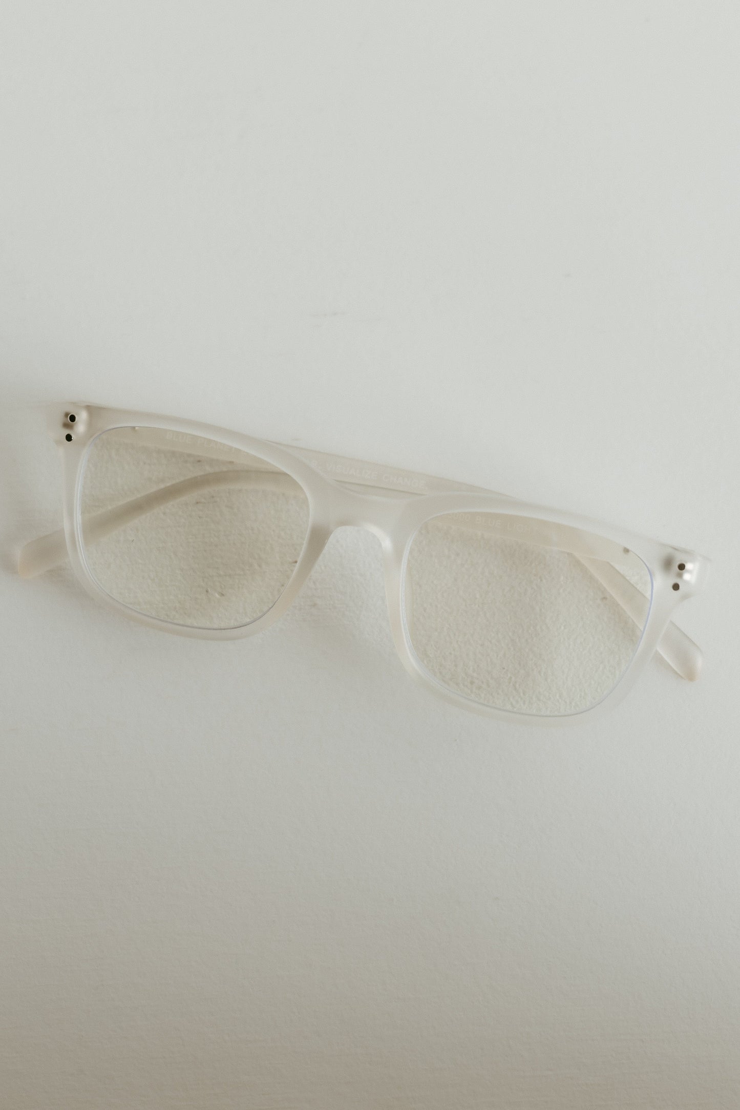 Clear sunglasses on a light gray background