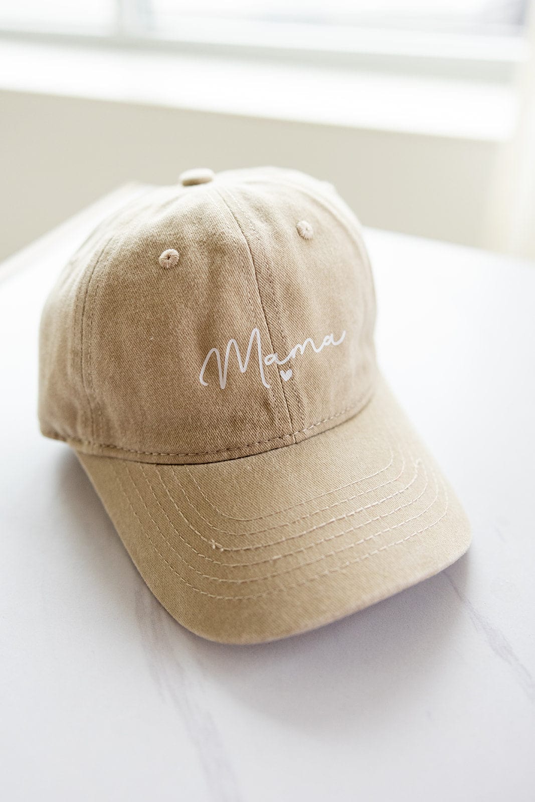 Introducing the perfect Mother's Day gift: an acid-washed beige MAMA Baseball Cap, featuring "Mama" elegantly embroidered in cursive on the front.