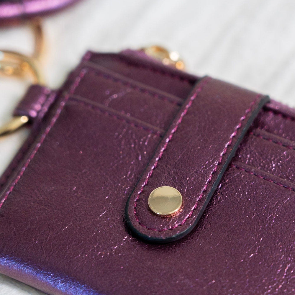 Show off your style with this metallic bangle wristlet wallet. Fold out the wallet to access your cards and IDs in secure snap closure — saving you from the rummage. Zip up your change pocket for a chic, sophisticated finish. Throw it on your wrist for easy access with an amethyst accent!