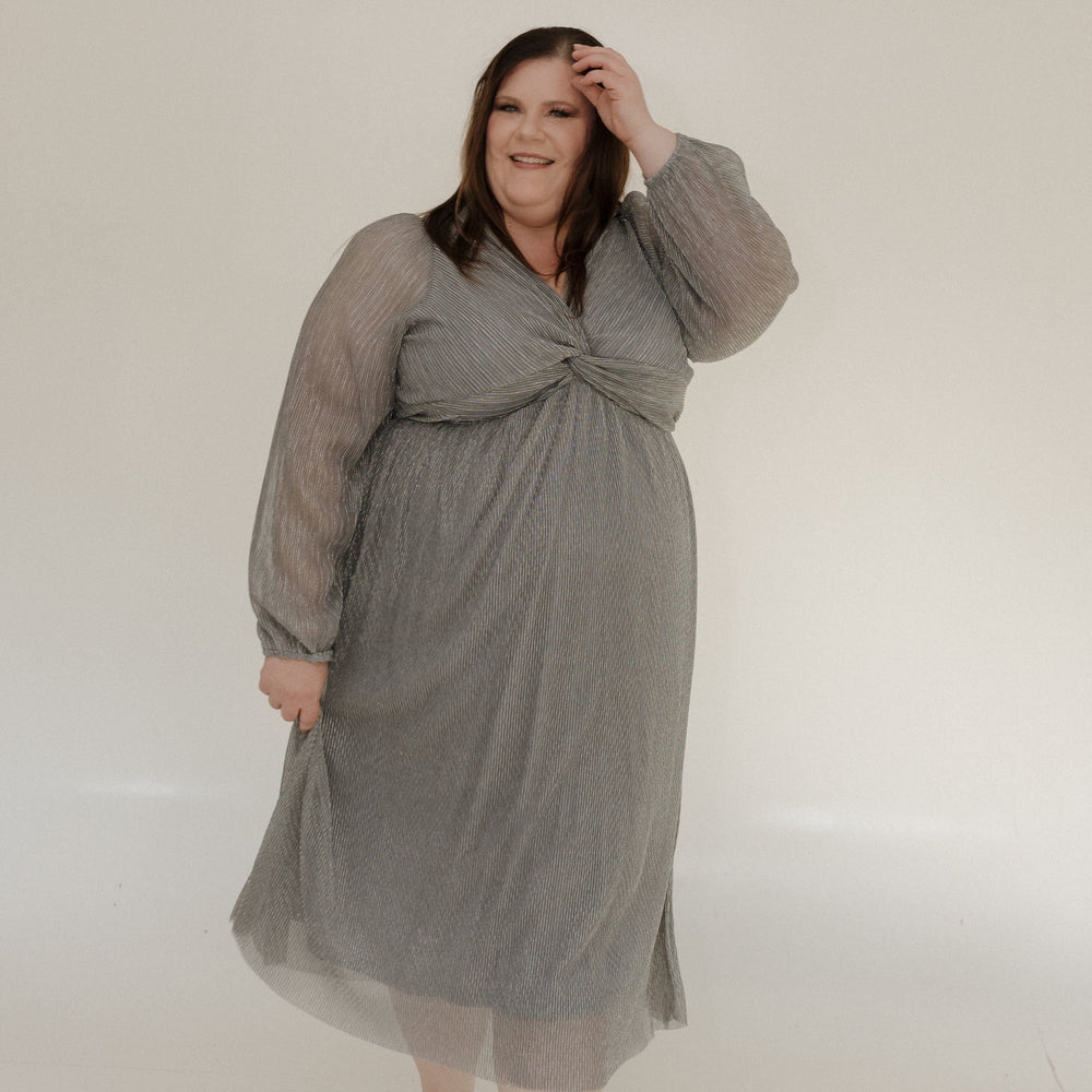 Woman wearing a gray dress against a white background