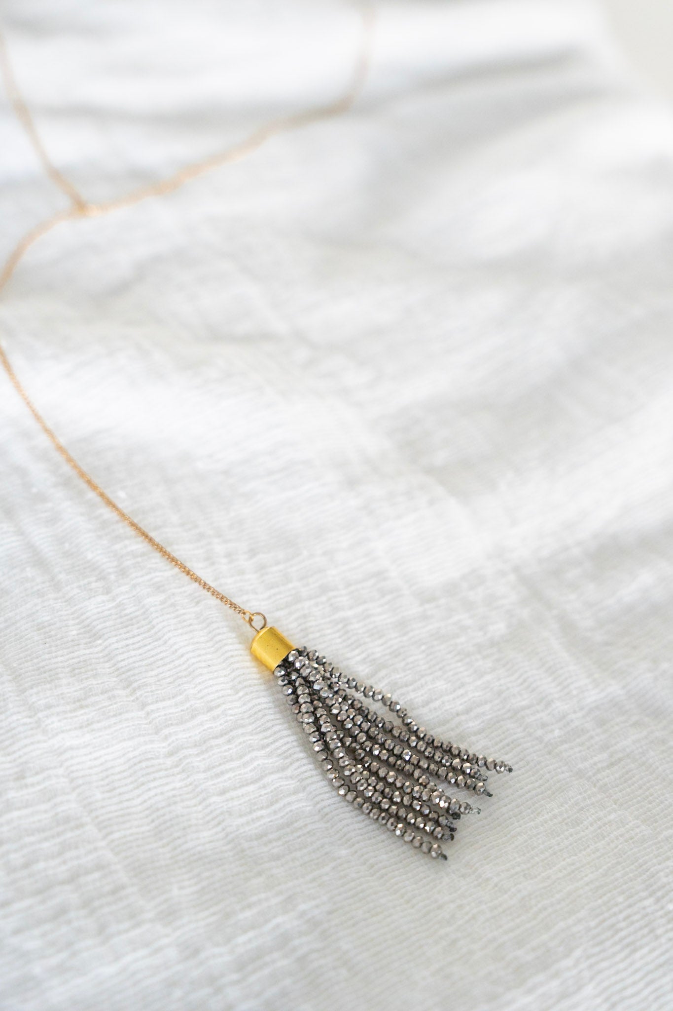 Nora Necklace in Gunmetal 
Gold long necklace with silver beaded tassel