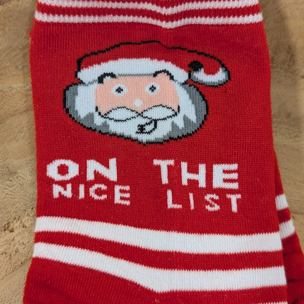 Cozy holiday sock featuring Santa's cheerful face and the text "ON THE NICE LIST" in crisp white letters.
