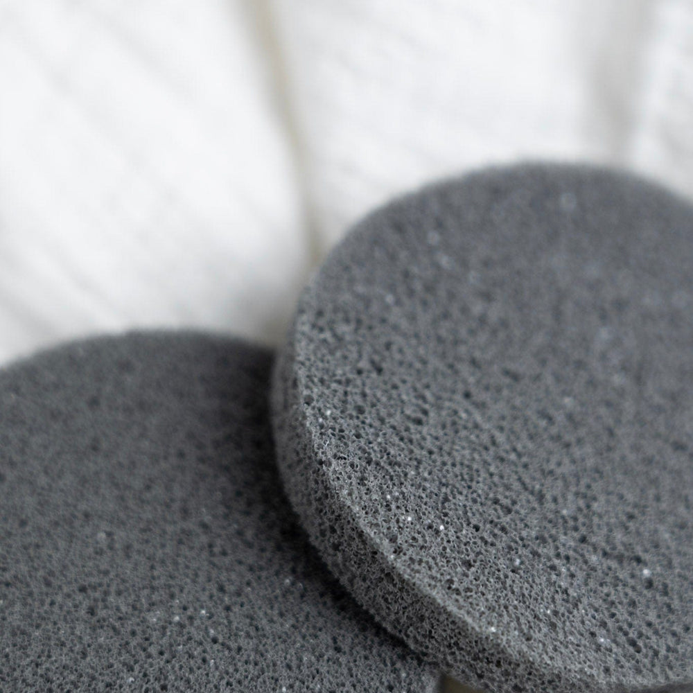 Two gray deodorant removers on a white background