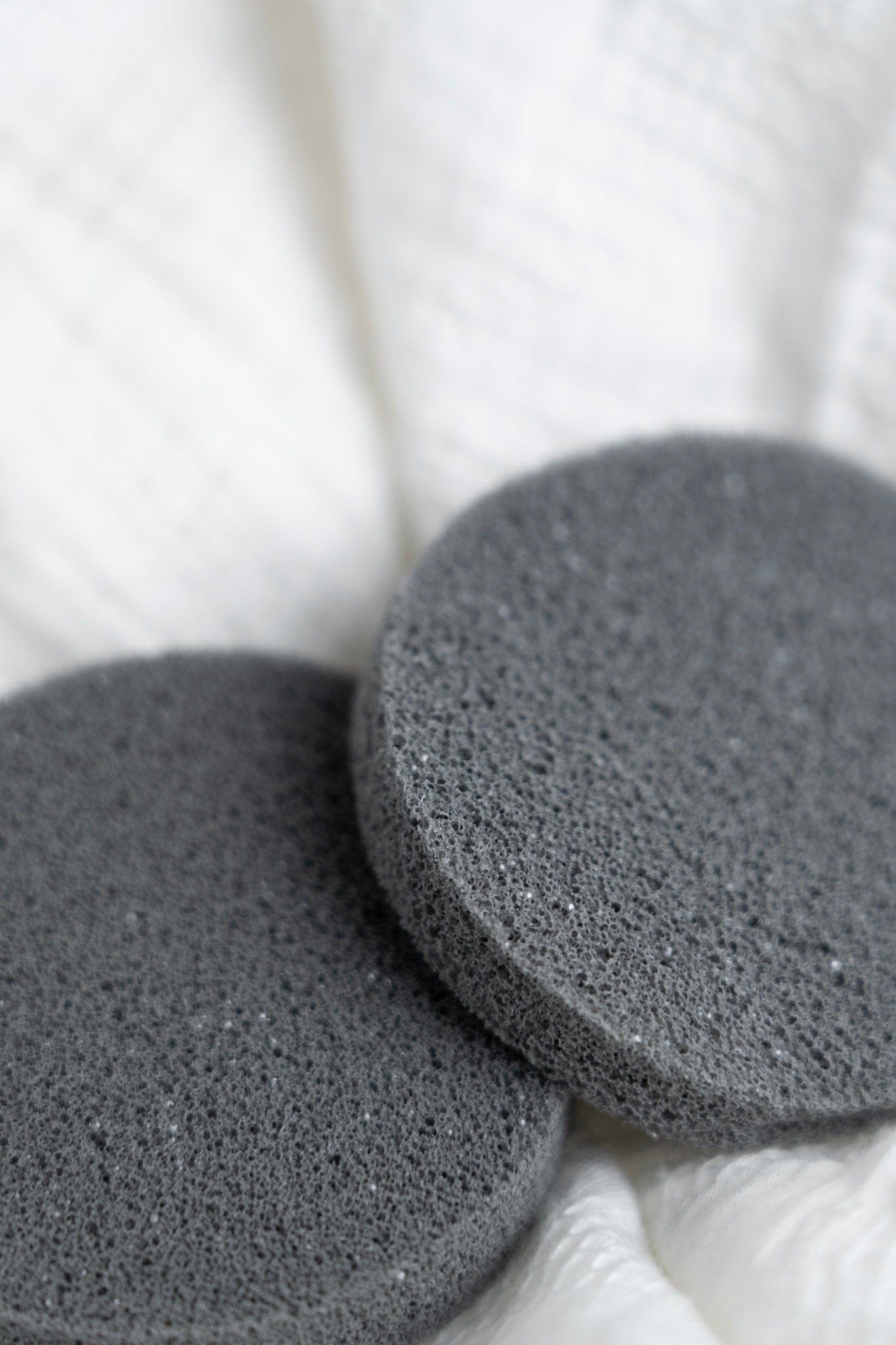 Two gray deodorant removers on a white background