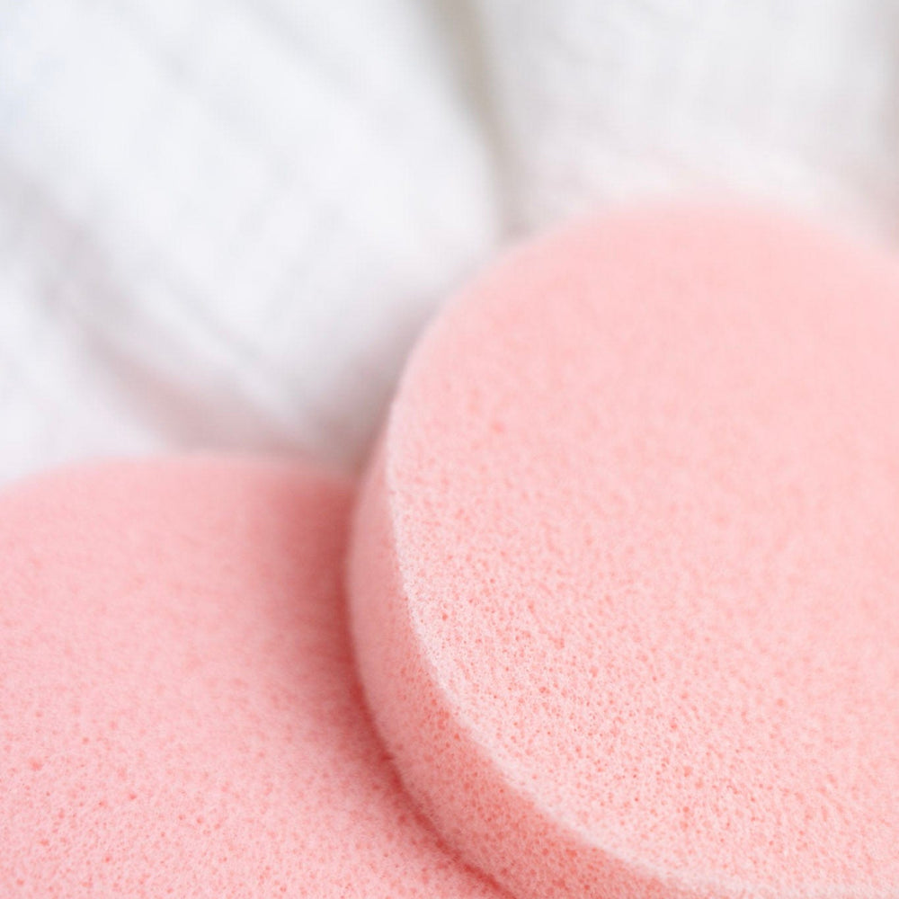 Close-up of pink deodorant removers on a white background