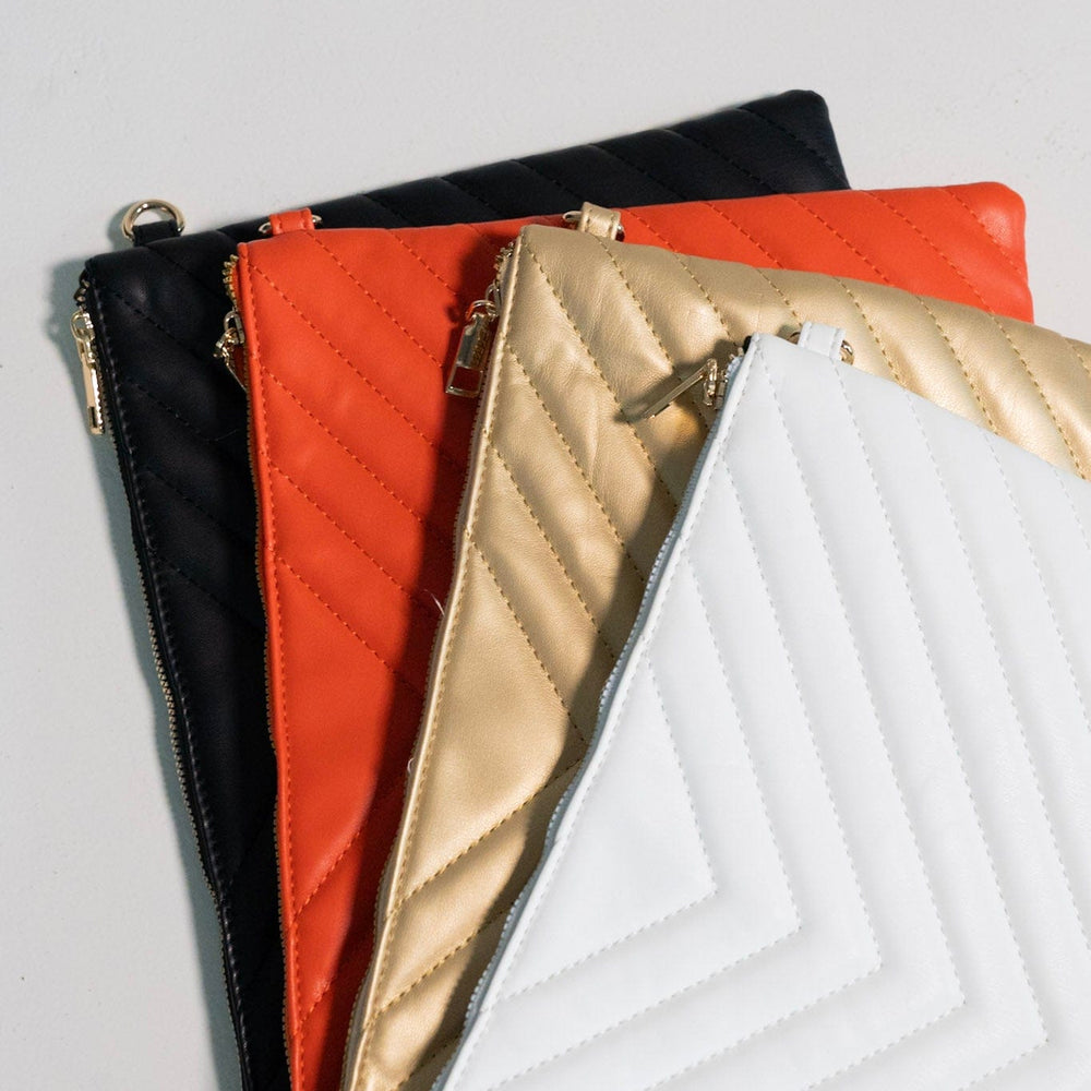 Set of quilted pouches in black, red, gold, and white on a light gray background