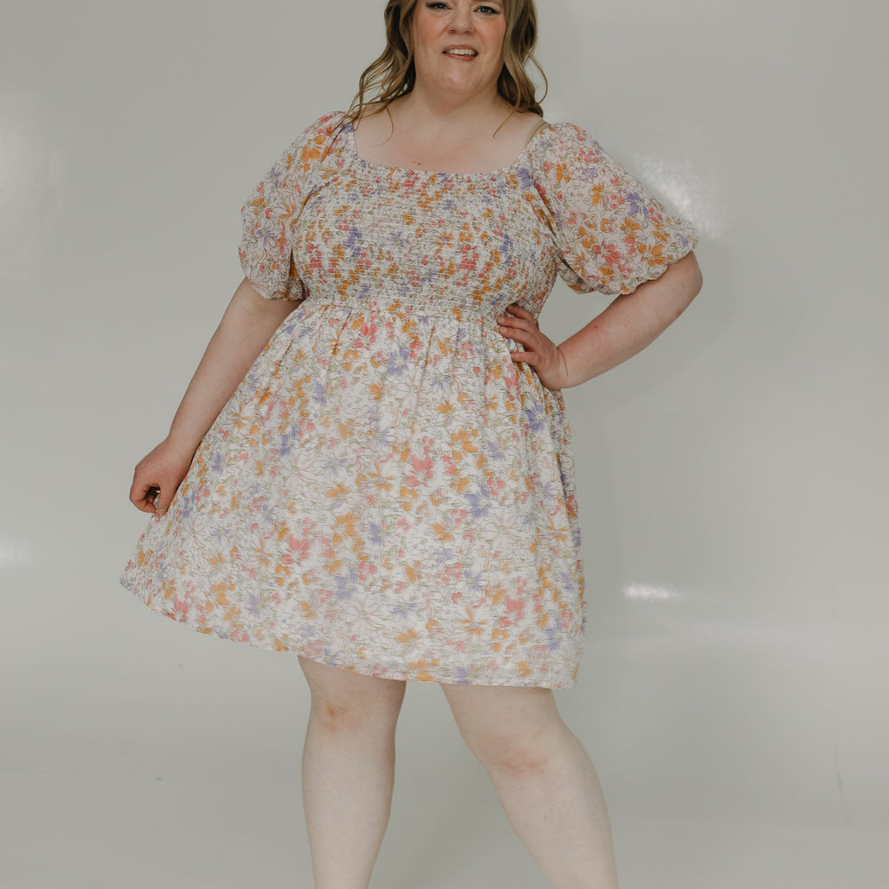 Woman wearing a floral dress against a white background