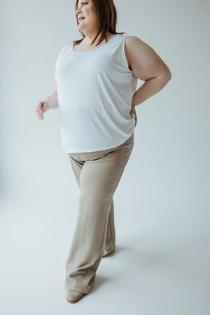 A person is standing sideways wearing a white sleeveless top and Yesta's LIGHT KHAKI STRAIGHT LEG PULL-ON PANT made of lightweight textured fabric in a neutral, well-lit space.