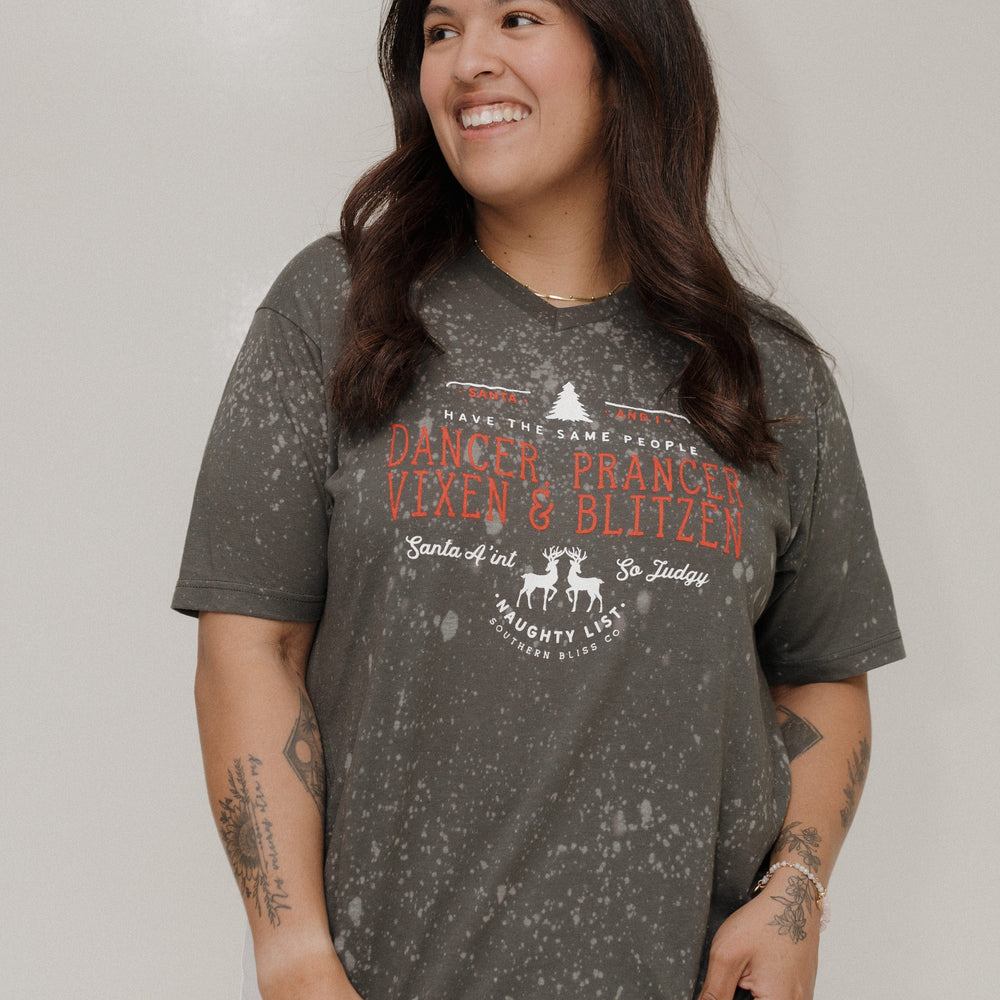 Woman wearing a gray t-shirt with text and graphics on a plain background