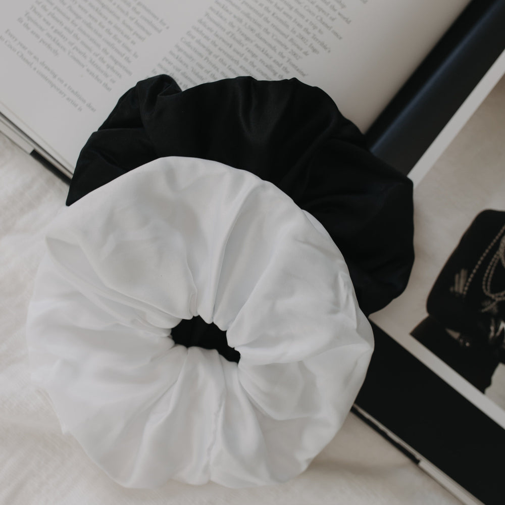 Black and white scrunchies on an open book Infinity Scrunchie