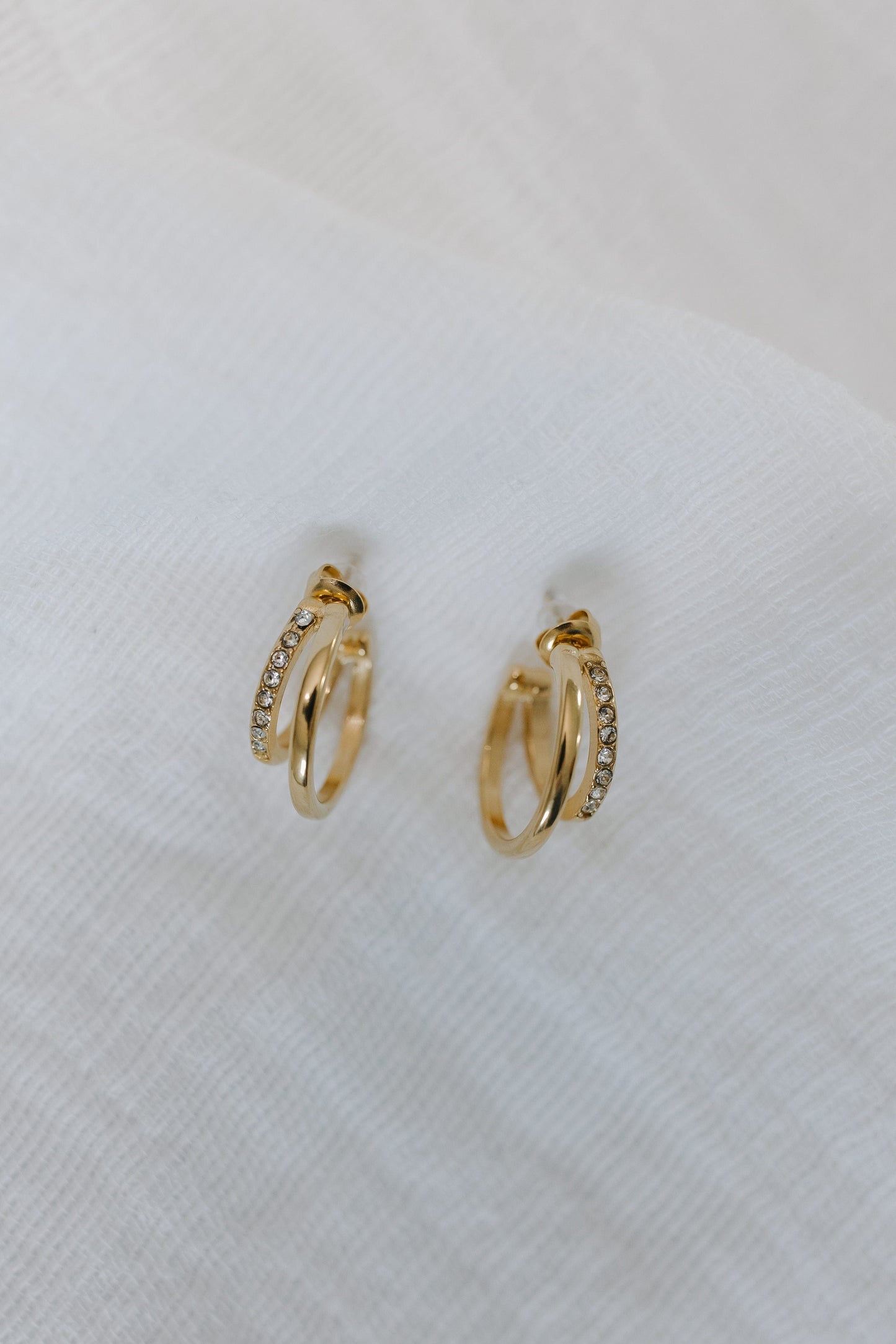 Gold hoop earrings on a white background