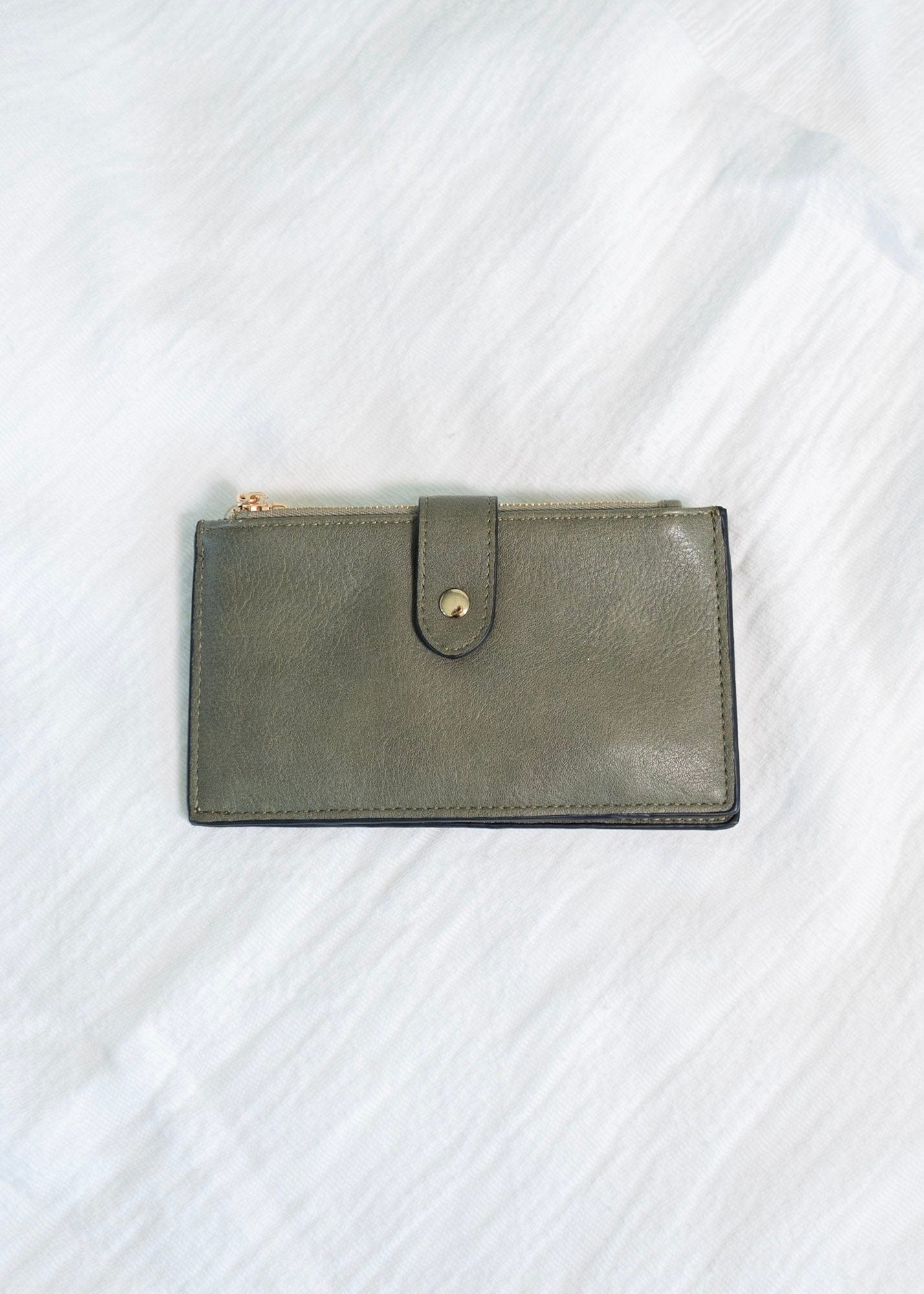 You'll make a statement with this army green wallet! This album style wallet has so much room for your cards and cash! It has two zipper pockets with a snap to keep the wallet closed. It is RFID protected! You will be protecting your personal data with the use of RFID blocking technology! A metal fiber mesh creates a "cage" around the chip on credit cards that radio waves cannot penetrate! Protect yourself and look cute all at the same time!