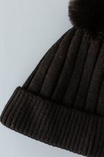 SOLID RIBBED KNIT BEANIE WITH PUFF IN BLACK