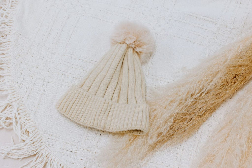 SOLID RIBBED KNIT BEANIE WITH PUFF IN IVORY