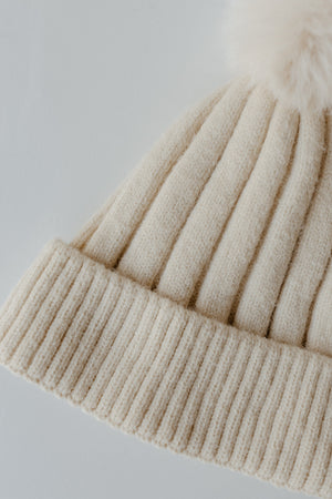 SOLID RIBBED KNIT BEANIE WITH PUFF IN IVORY