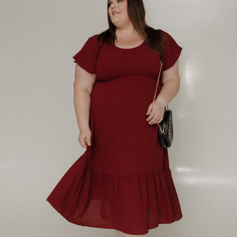 Woman wearing a red dress against a white background