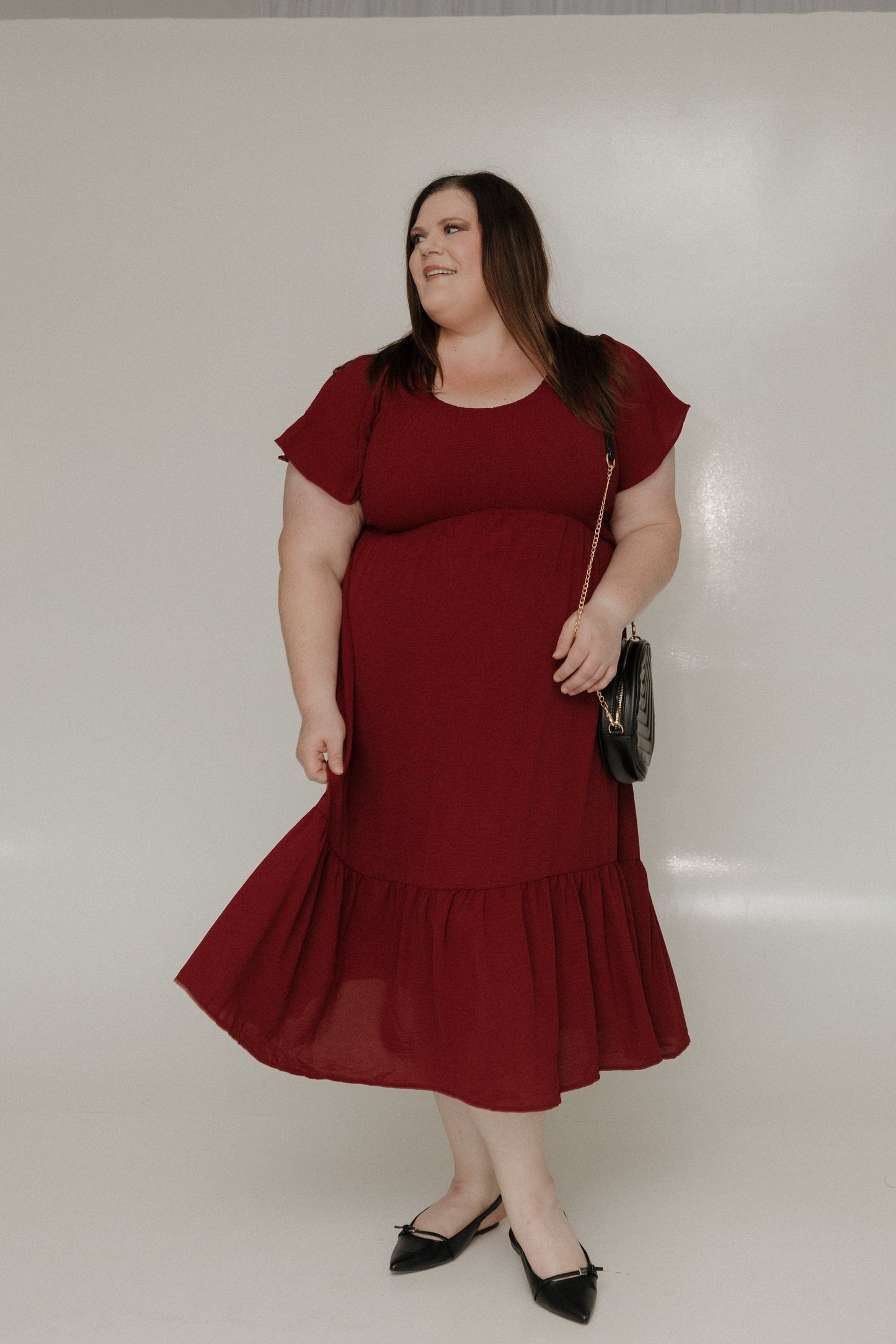 Woman wearing a red dress against a white background