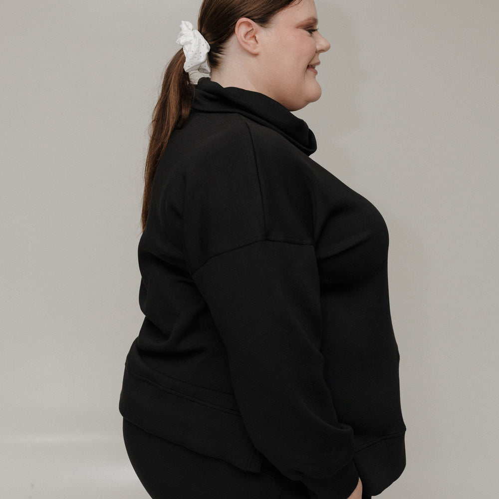 Person wearing a black outfit with a white background